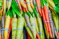 Organic rainbow carrots bunched in rubber bands at food store in America