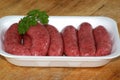 organic raw beef sausages and parsley Royalty Free Stock Photo
