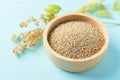 Organic raw brown quinoa seed in wooden bowl