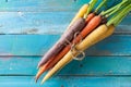 Organic Raw Carrots Bunch Tied On Colorful Blue Wood Texture Tab Royalty Free Stock Photo