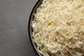 Organic Raw Cauliflower Rice in a Bowl on a gray background, top view. Flat lay, overhead, from above. Copy space Royalty Free Stock Photo