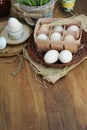 Organic raw chicken eggs in egg box on old style wooden background Royalty Free Stock Photo