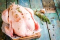 Organic raw chicken with thyme, peppers and garlic on a rustic table Royalty Free Stock Photo