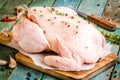 Organic raw chicken with thyme and peppers on a rustic table Royalty Free Stock Photo