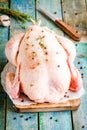Organic raw farm chicken with thyme and peppers on a rustic table Royalty Free Stock Photo