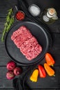 Organic Raw Grass Fed Ground Beef, on black wooden table background, top view flat lay Royalty Free Stock Photo