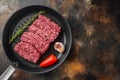 Organic Raw Grass Fed Ground Beef, on old dark rustic background, top view flat lay  with copy space for text Royalty Free Stock Photo