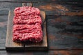 Organic Raw Grass Fed Ground Beef, on old dark  wooden table background  with copy space for text Royalty Free Stock Photo