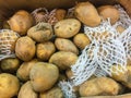 Organic raw potatoes for sale in the supermarket stand. Pile of potatoes in the food market for background Royalty Free Stock Photo