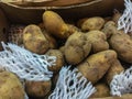 Organic raw potatoes for sale in the supermarket stand. Pile of potatoes in the food market for background Royalty Free Stock Photo