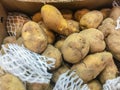 Organic raw potatoes for sale in the supermarket stand. Pile of potatoes in the food market for background Royalty Free Stock Photo