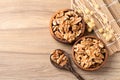 Organic raw walnuts in wooden bowl, top view