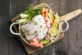 organic raw whole chicken with thyme peppers and garlic on a rustic table Royalty Free Stock Photo