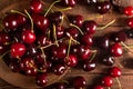 Organic red cherries in rustic plate on the wooden  background Royalty Free Stock Photo