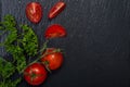 Organic Red Tomatoes on the vine and fresh Curly Parsley arranged on natural stone. Solanum lycopersicum. Petroselinum Royalty Free Stock Photo