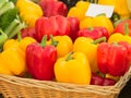 Organic red and yellow pepper in a wicker basket Royalty Free Stock Photo