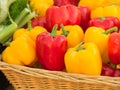 Organic red and yellow pepper in a wicker basket Royalty Free Stock Photo