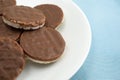 Organic rice cookies with milk chocolate icing on plate