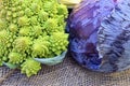Organic ripe green Romanesco broccoli Roman cauliflower and Scotch kale or red cabbage on a sack background. Royalty Free Stock Photo