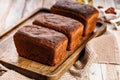 Organic rye bread loafs. Fresh bread made from whole grain rye flour. Homemade delicious pastries on a wooden tray Royalty Free Stock Photo