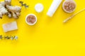 Natural herbal cosmetics with ginger and wheat on yellow background top view space for text Royalty Free Stock Photo