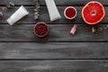 Natural herbal cosmetics with grapefruit on wooden background top view space for text Royalty Free Stock Photo