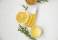 Organic skincare ingredients top view, lemon and rosemary oil bottle and herb, manuka honey and balm salve