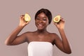 Organic Skincare. Portrait of happy african american woman holding avocado halves Royalty Free Stock Photo