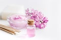 Organic soap, cream, extract in lilac cosmetic set with flowers on white table background
