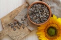 Organic sunflower seeds and flower on wooden table, flat lay Royalty Free Stock Photo