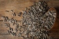 Organic sunflower seeds on wooden table, flat lay Royalty Free Stock Photo