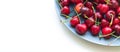 Organic sweet cherries in gray plate isolated Royalty Free Stock Photo