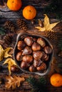 Organic sweet chestnuts in a bowl on kitchen table