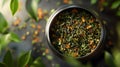 Organic tea leaves in a tin with looses leaves scattered Royalty Free Stock Photo