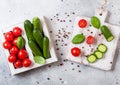 Organic Tomatoes with basil in vintage wooden box on stone kitchen table background. San Marzano, orange and plum tomatoes Royalty Free Stock Photo