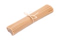 Organic uncooked Brown Rice Spaghetti pasta tied with a straw isolated on white background. Gluten-free and sodium-free