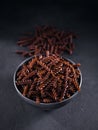 Organic uncooked Buckwheat Fusilli pasta on a dark background