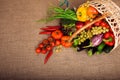 Organic vegetables, fruits and lettuce in wicker basket on kitchen table. Royalty Free Stock Photo