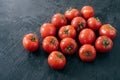 Organic vegetables and healthy eating concept. Harvested red tomatoes with water drops, black background. Close up texture. Open Royalty Free Stock Photo