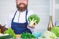 Organic vegetables. I choose only healthy ingredients. Man cook hat and apron hold broccoli. Healthy nutrition concept Royalty Free Stock Photo