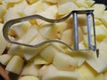 Potatoe peeler on a heap of potatoes Royalty Free Stock Photo