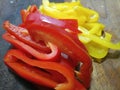 Close up of sliced and washed peppers on a wooden board