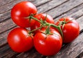 Organic Vine ripe tomatoes on wooden table Royalty Free Stock Photo