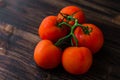 Organic Vine ripe tomatoes on wooden table Royalty Free Stock Photo