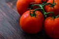 Organic Vine ripe tomatoes on wooden table Royalty Free Stock Photo