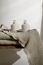 Organic waffle linen towels, soap and lotion dispensers, bathroom zero waste accessories in modern bathroom interior..