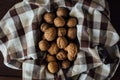 Many organic walnuts on towel