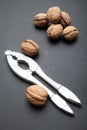Organic walnuts, kernels and nutcrackers on a black background Royalty Free Stock Photo