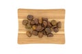 Organic whole shelled roasted chestnuts on a cutting board