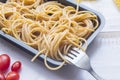 Organic whole wheat bunch of raw italian spaghetti pasta on a white table background, selective focus. Royalty Free Stock Photo